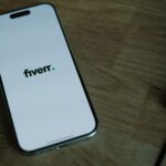 A cell phone sitting on a top of wodden table
