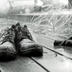 Abandoned Shoes in Rain on Wooden Deck