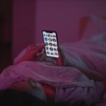 A Woman Lying on Bed while using Smartphone