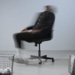 Blurred Photo of a Man Sitting on an Office Chair