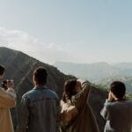 Group of People Taking Pictures of a Mountain