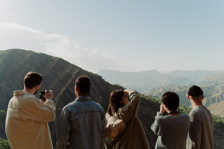 Group of People Taking Pictures of a Mountain