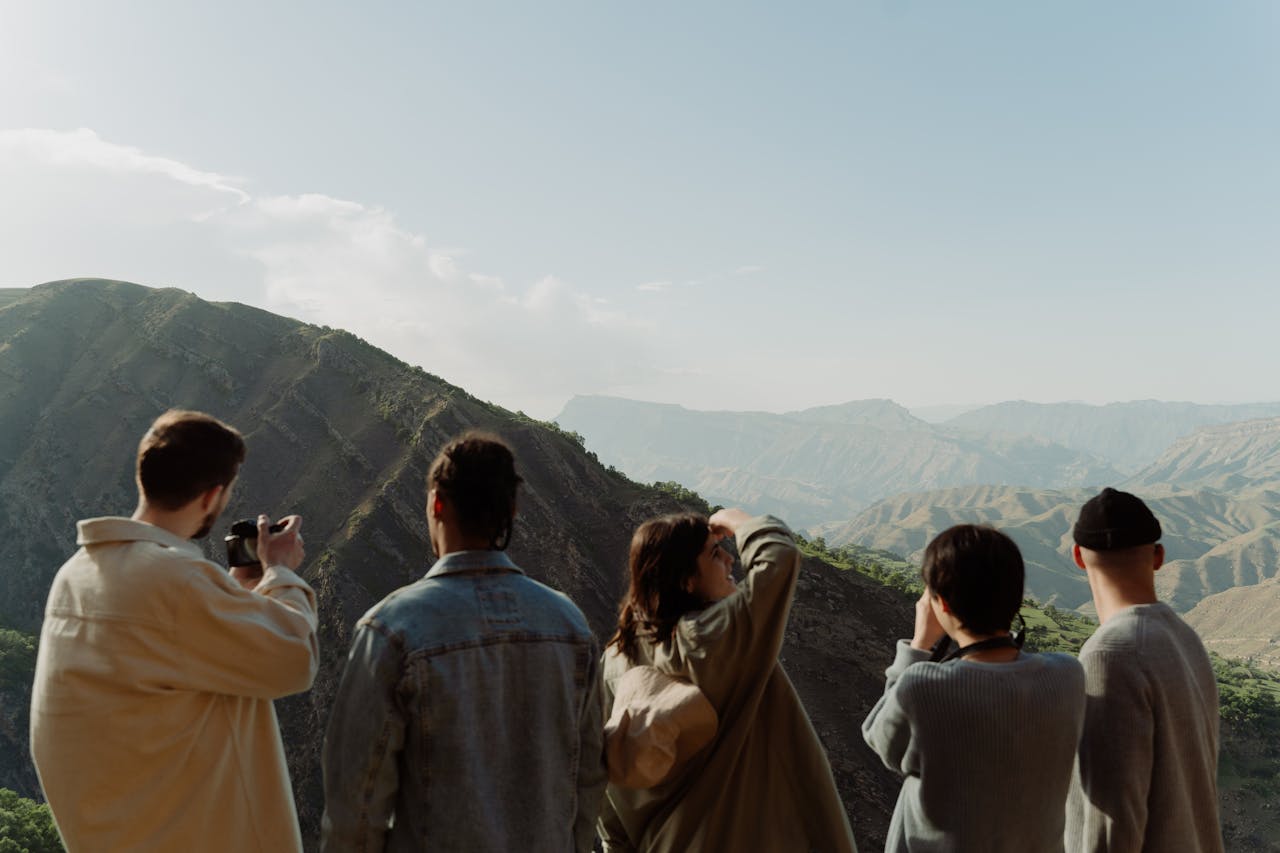 Group of People Taking Pictures of a Mountain