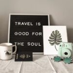 A frame on table written, Travel is good for the soul