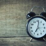 Black Analog Alarm Clock at 7:01