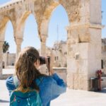 A girl is standing with camera