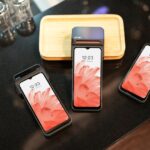 Different phones placed in a black surface.