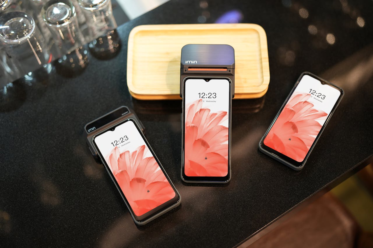 Different phones placed in a black surface.
