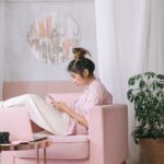 A Woman Relaxing on a Pink Sofa Chair