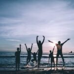 5 persons chilling near the beach