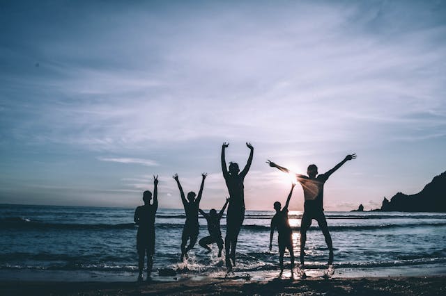 5 persons chilling near the beach