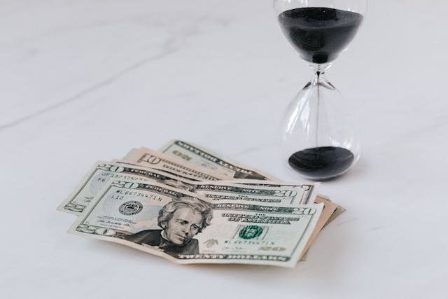 Dollars with time sand equipment on the table