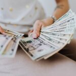 Person Holding Fan of Us Dollar Bills