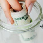 Dollar pit in the jar by hand