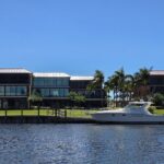 Modern Waterfront Villa with Yacht and Palm Trees