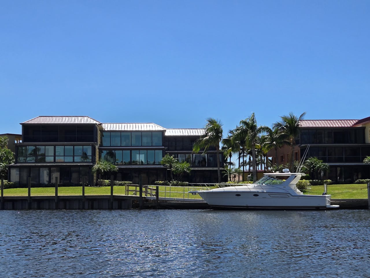 Modern Waterfront Villa with Yacht and Palm Trees