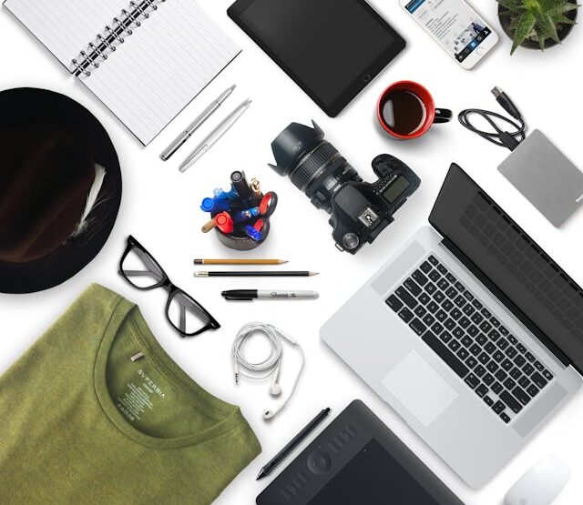 Different gadgets and a shirt and a pair of glasses.