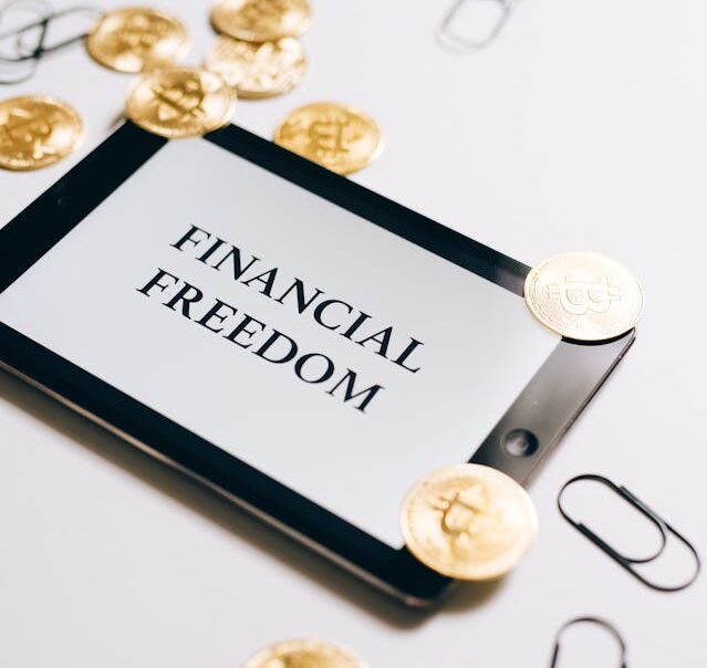 Financial freedom written on a white background with some coins side by side