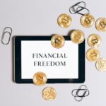 Financial Freedom written on blank paper with some coins