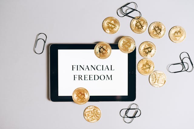 Financial Freedom written on blank paper with some coins