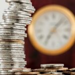 Coins with blur wall clock background
