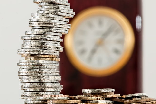 Coins with blur wall clock background