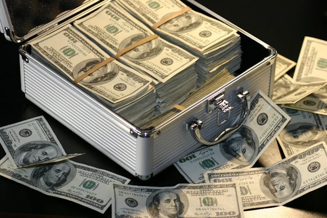 Currency notes of dollars in an open briefcase