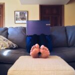 A man using laptop on a couch.