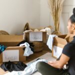 A Woman Sitting in front of Cardboard Boxes