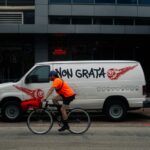 Bicycle Courier Riding Past Non Grata Van in Houston