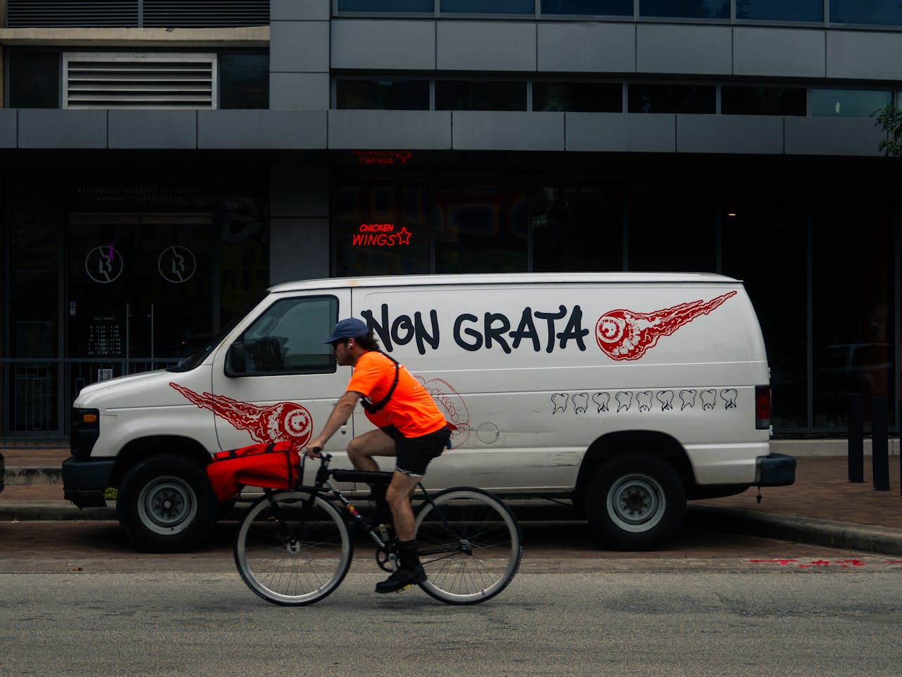 Bicycle Courier Riding Past Non Grata Van in Houston