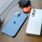Two smartphones places on a table.