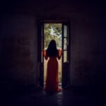 Silhouette of a Woman Standing on the Threshold