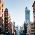 City street with new and aged multistory buildings in sunlight