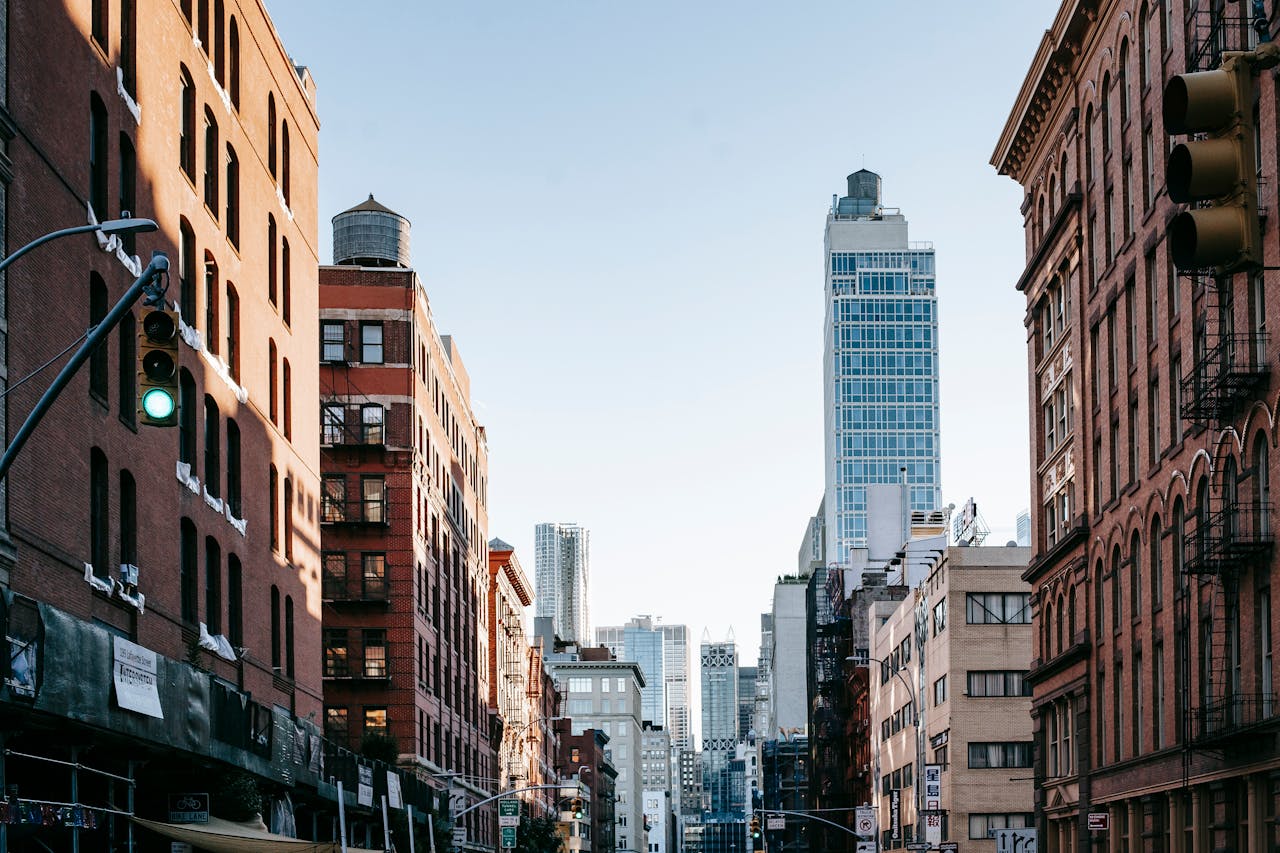 City street with new and aged multistory buildings in sunlight
