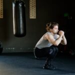 Man in Gray Tank Top Doing Squats