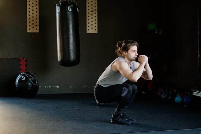 Man in Gray Tank Top Doing Squats