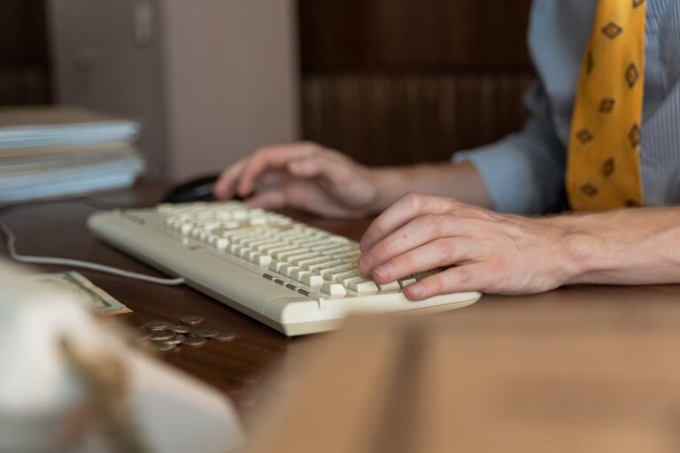 A Person's Hands Typing on a Keyboard