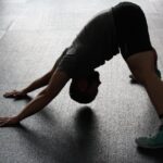 Man in Grey Shirt Doing Yoga on Gray Ceramic Tile Floor