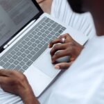 A Person Browsing the Documents on a Laptop