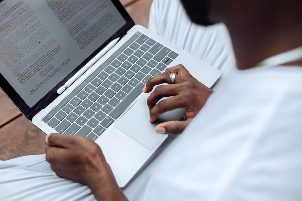 A Person Browsing the Documents on a Laptop
