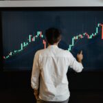 A Man Standing Infront of Blockchain Graph