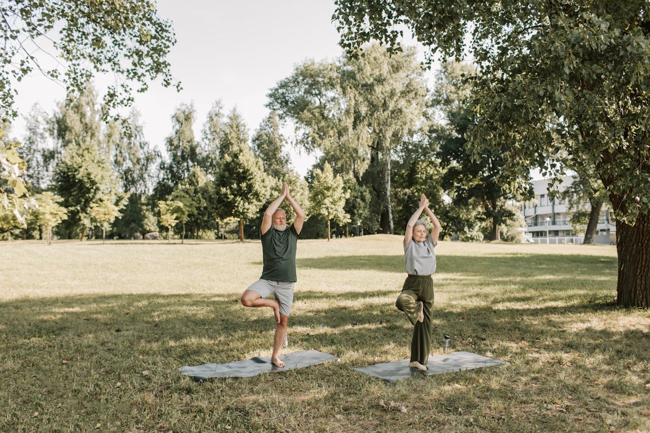 An Elderly Couple Doing Yoga at the Park